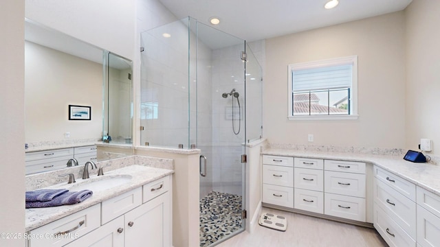 bathroom with recessed lighting, a shower stall, and vanity