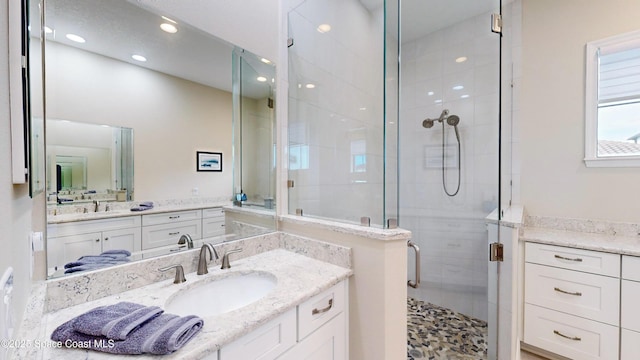 bathroom featuring recessed lighting, a stall shower, and vanity