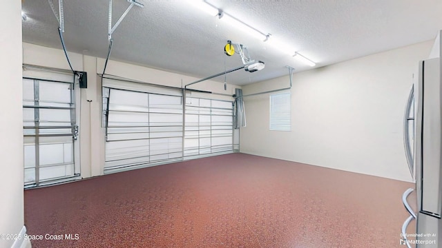 garage with a garage door opener and freestanding refrigerator