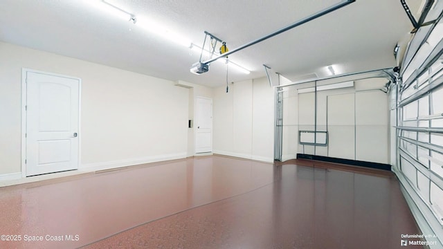 garage featuring a garage door opener and baseboards