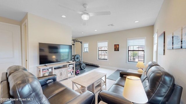 living room with a wealth of natural light, visible vents, and recessed lighting