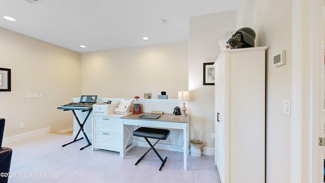 office space featuring light wood finished floors, recessed lighting, and baseboards