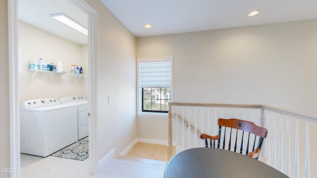 clothes washing area featuring washer and dryer, laundry area, recessed lighting, and baseboards