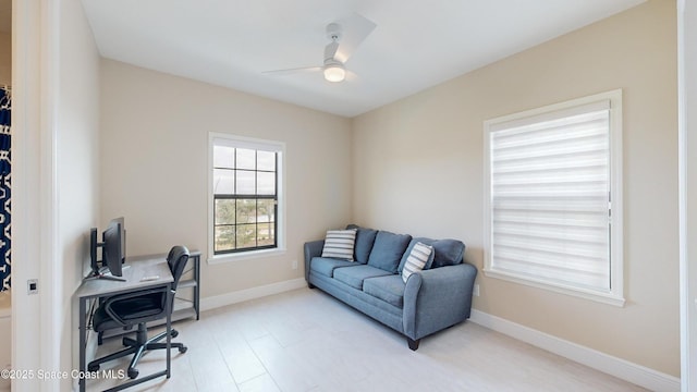 home office featuring a ceiling fan and baseboards