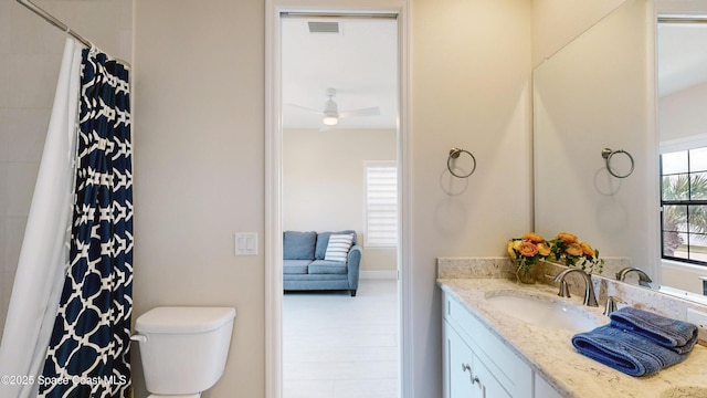 full bathroom with visible vents, toilet, curtained shower, ceiling fan, and vanity