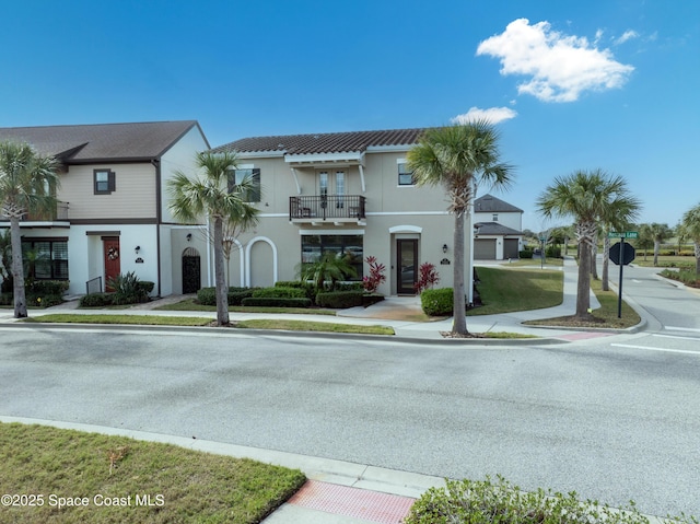 view of front of home with a balcony and stucco siding