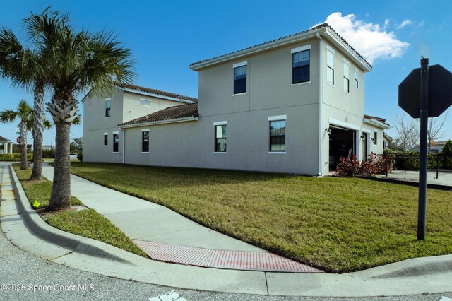 view of home's exterior with a yard and stucco siding