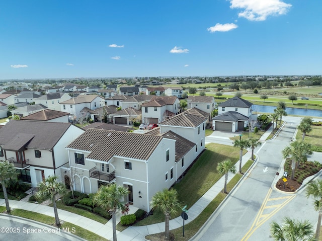 bird's eye view featuring a residential view and a water view