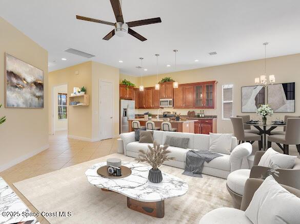 living room with light tile patterned flooring, sink, and ceiling fan with notable chandelier