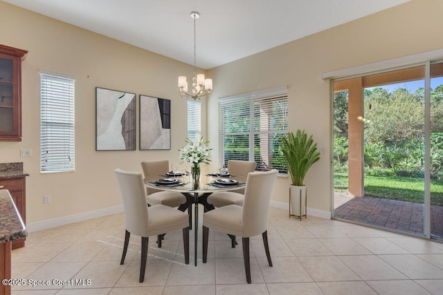 dining area featuring light tile patterned flooring and an inviting chandelier