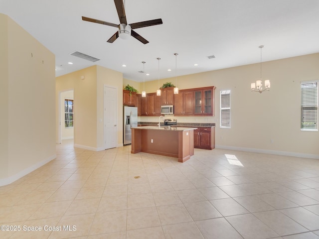 kitchen featuring stainless steel appliances, light tile patterned flooring, a kitchen island with sink, and pendant lighting