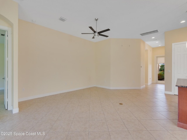 spare room featuring light tile patterned floors and ceiling fan