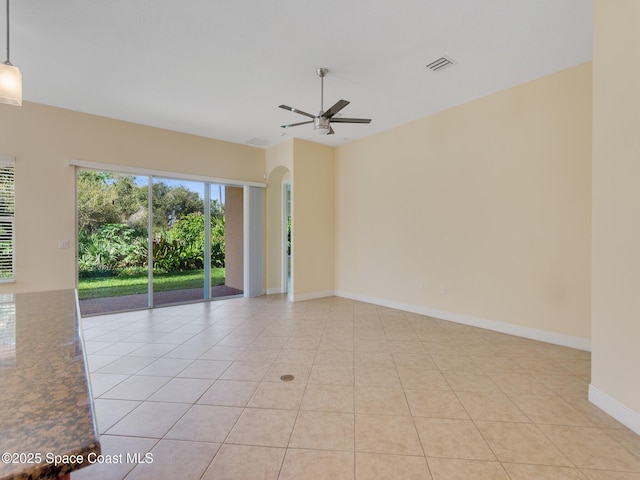 empty room featuring ceiling fan and light tile patterned floors