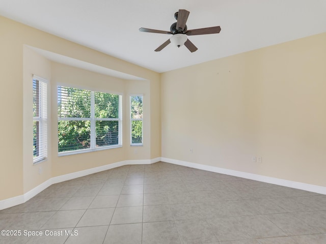 empty room with light tile patterned flooring and ceiling fan