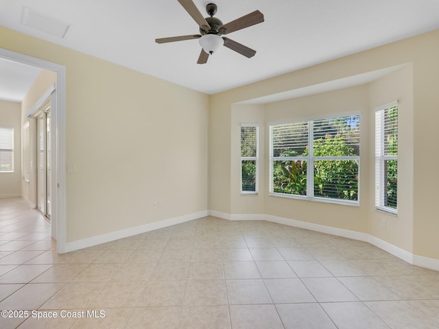 unfurnished room featuring light tile patterned floors and ceiling fan