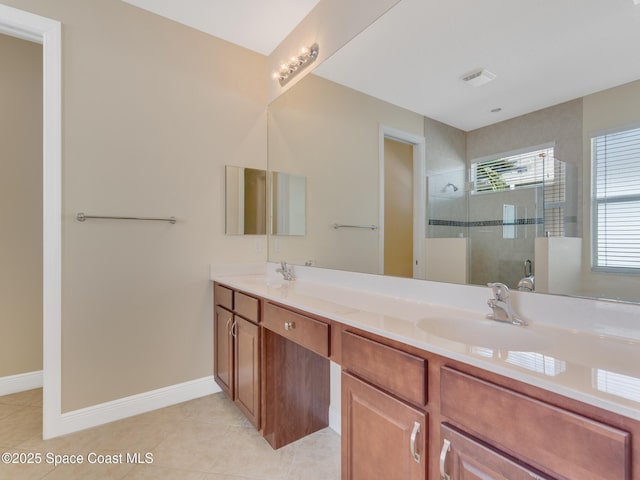 bathroom with an enclosed shower, vanity, and tile patterned flooring