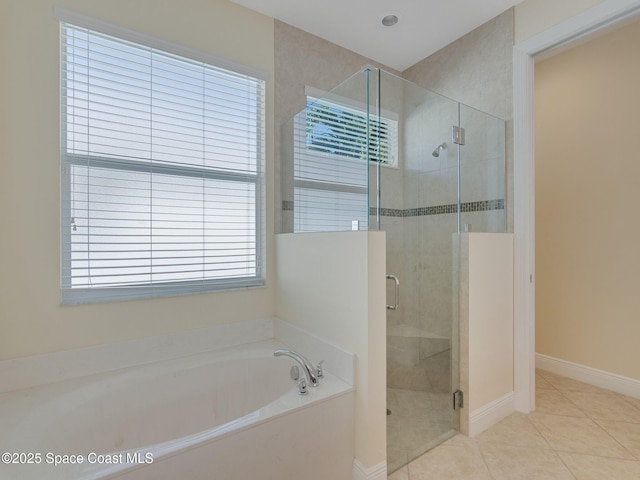 bathroom featuring tile patterned flooring, shower with separate bathtub, and a wealth of natural light