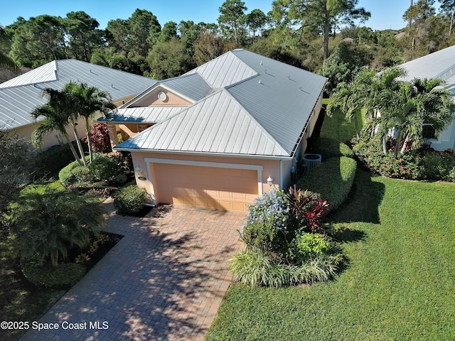 exterior space featuring a garage and a front yard