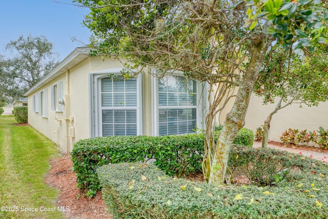 view of property exterior with a yard