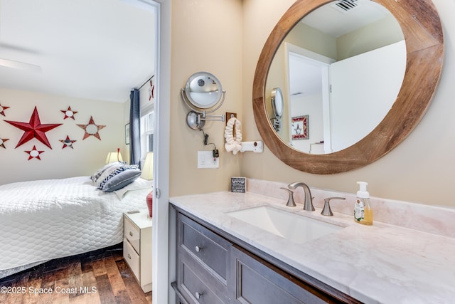 bathroom featuring hardwood / wood-style flooring, vanity, and ceiling fan