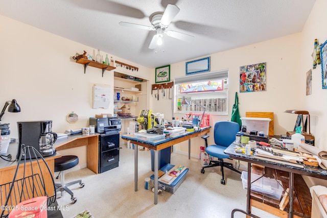 office space featuring a workshop area, ceiling fan, and a textured ceiling