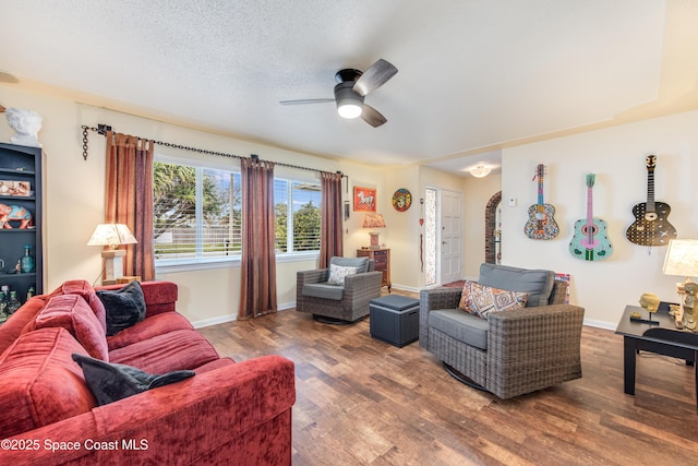 living room with ceiling fan, hardwood / wood-style floors, and a textured ceiling