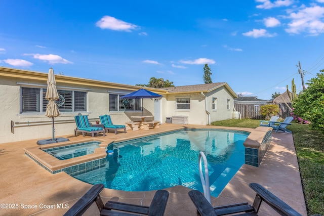 view of pool featuring a patio area and an in ground hot tub