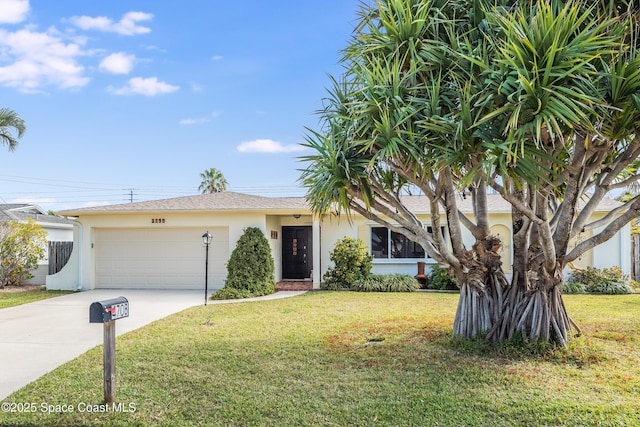 view of front of property with a garage and a front yard