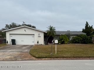 ranch-style house with a garage and a front yard