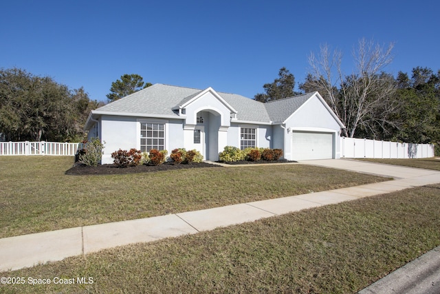 ranch-style house featuring a garage and a front yard