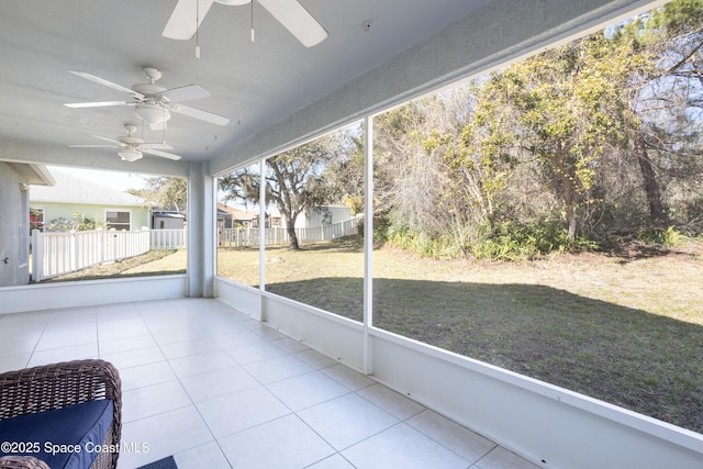 unfurnished sunroom with ceiling fan