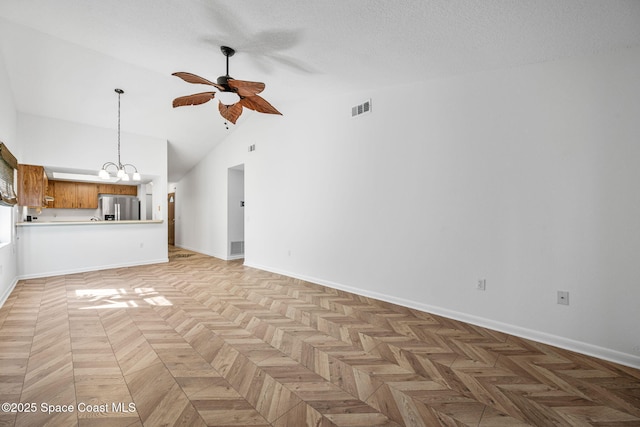 unfurnished living room with high vaulted ceiling, light parquet flooring, ceiling fan with notable chandelier, and a textured ceiling