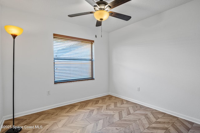 spare room with light parquet flooring and ceiling fan