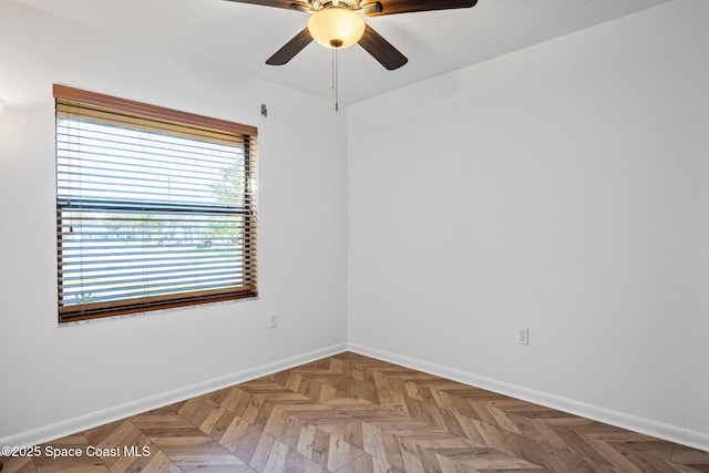 empty room featuring parquet floors and ceiling fan