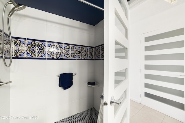 bathroom featuring tiled shower and tile patterned floors