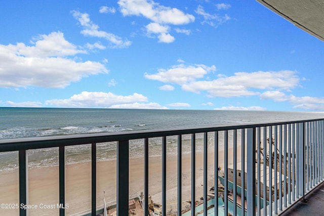 balcony featuring a beach view and a water view