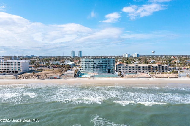 drone / aerial view featuring a water view and a view of the beach