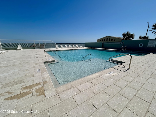 800 N Atlantic Ave Unit 705, Daytona Beach, FL 32118 - community pool with a patio area and fence
