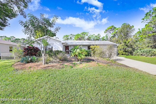 ranch-style home with a front lawn