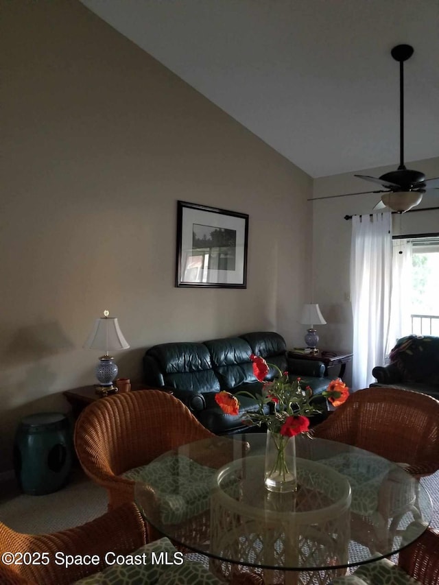 living room featuring ceiling fan and vaulted ceiling