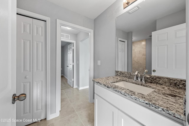 bathroom with tile patterned flooring and vanity