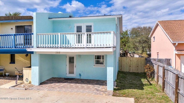 view of front of property with a balcony