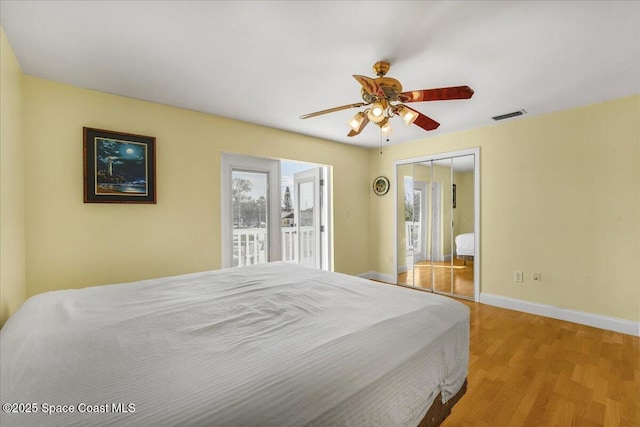 bedroom with a closet, visible vents, light wood-style floors, a ceiling fan, and baseboards