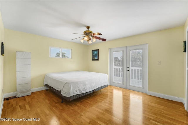 bedroom with baseboards, ceiling fan, wood finished floors, access to exterior, and french doors