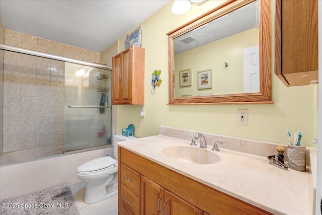 full bathroom with visible vents, bath / shower combo with glass door, toilet, tile patterned floors, and vanity