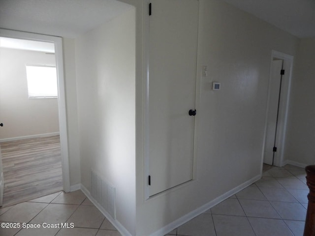 hall featuring light tile patterned floors