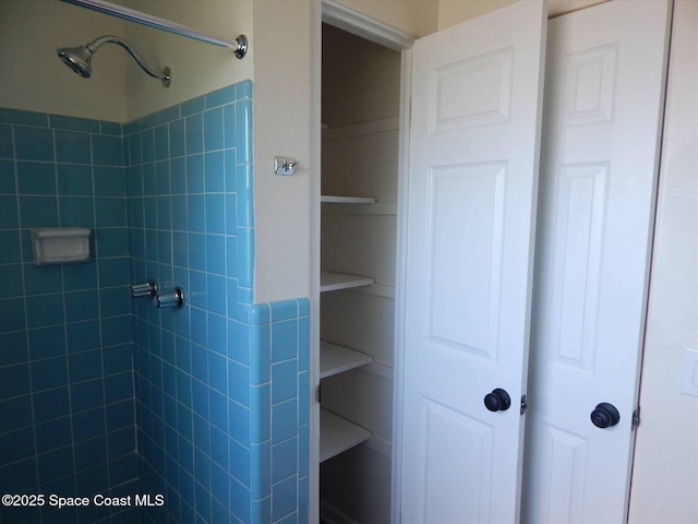 bathroom with tiled shower