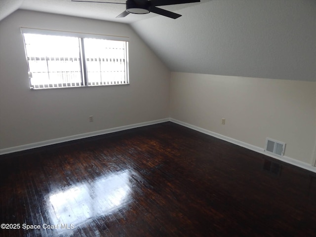 bonus room featuring vaulted ceiling, ceiling fan, and dark hardwood / wood-style flooring