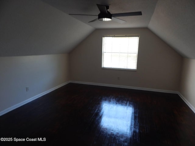 bonus room featuring lofted ceiling, dark wood-type flooring, and ceiling fan