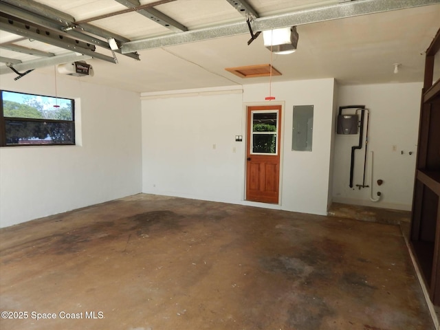 garage featuring a garage door opener and electric panel